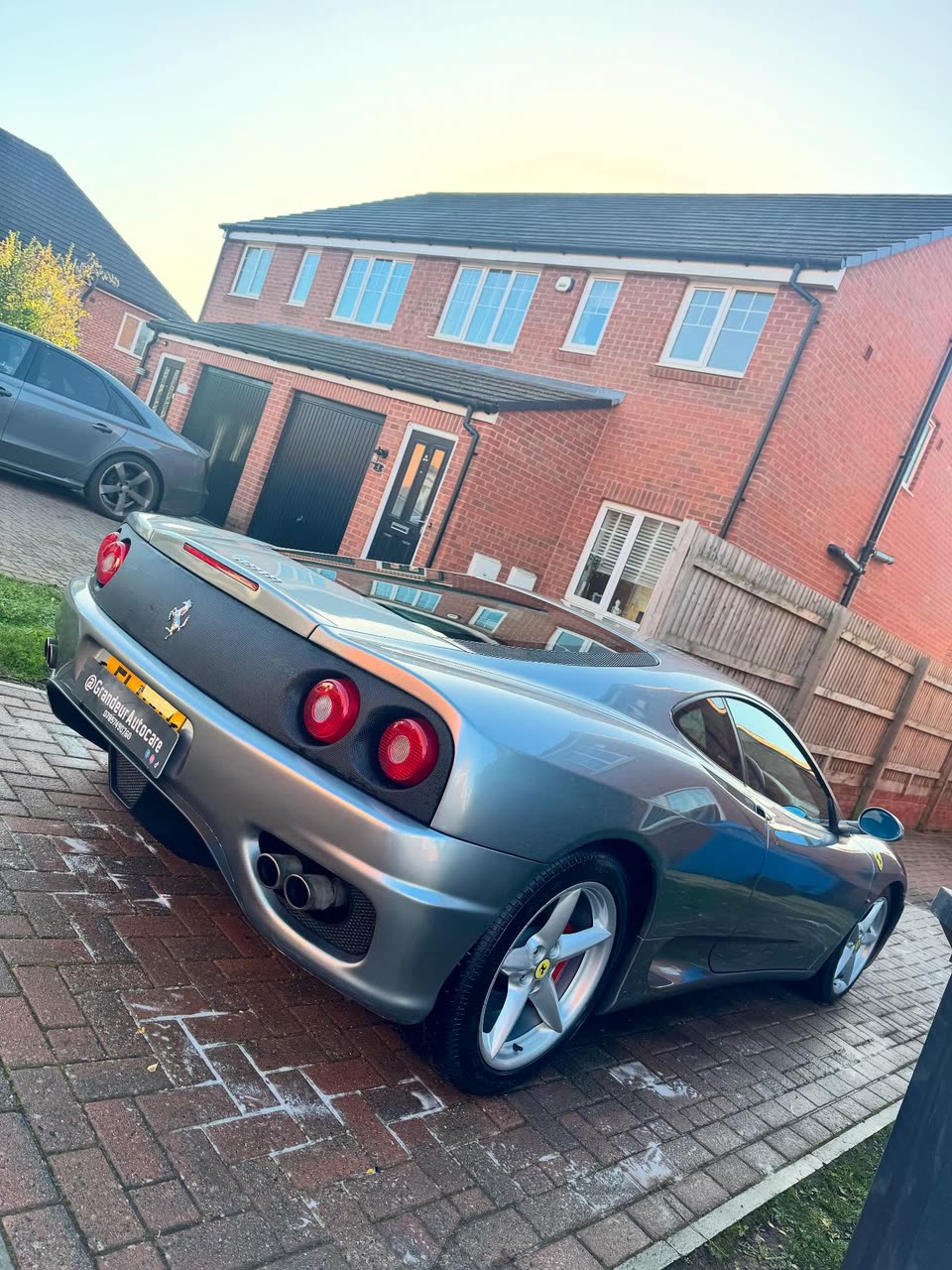 Silver Ferrari 360 on a block-paved driveway after a wash and detail