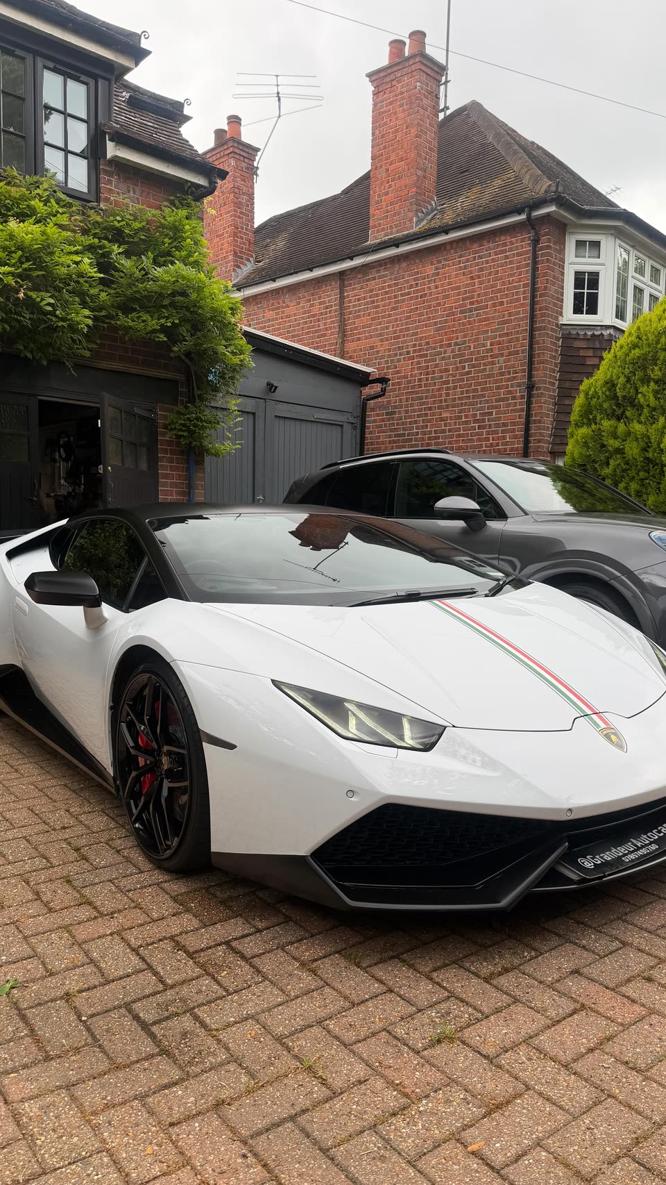 White Lamborghini Huracán with red pinstripe after a detail