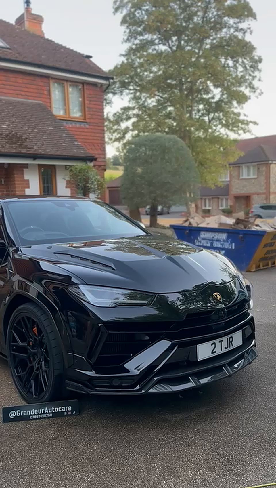 Black Lamborghini Urus after a detail on a driveway